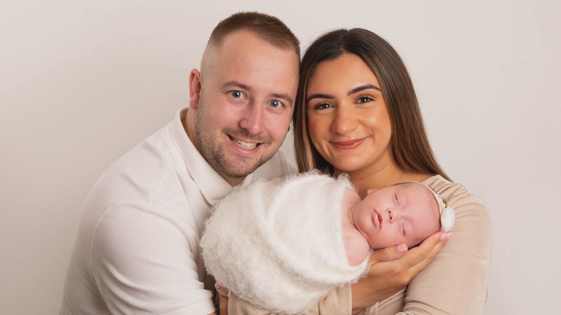 Aisha with husband David and baby Sophie.