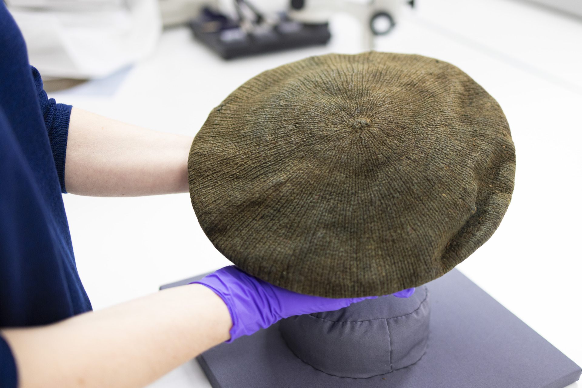 Conservator Lynn McClean prepares the Arnish Moor Man's knitted bonnet.