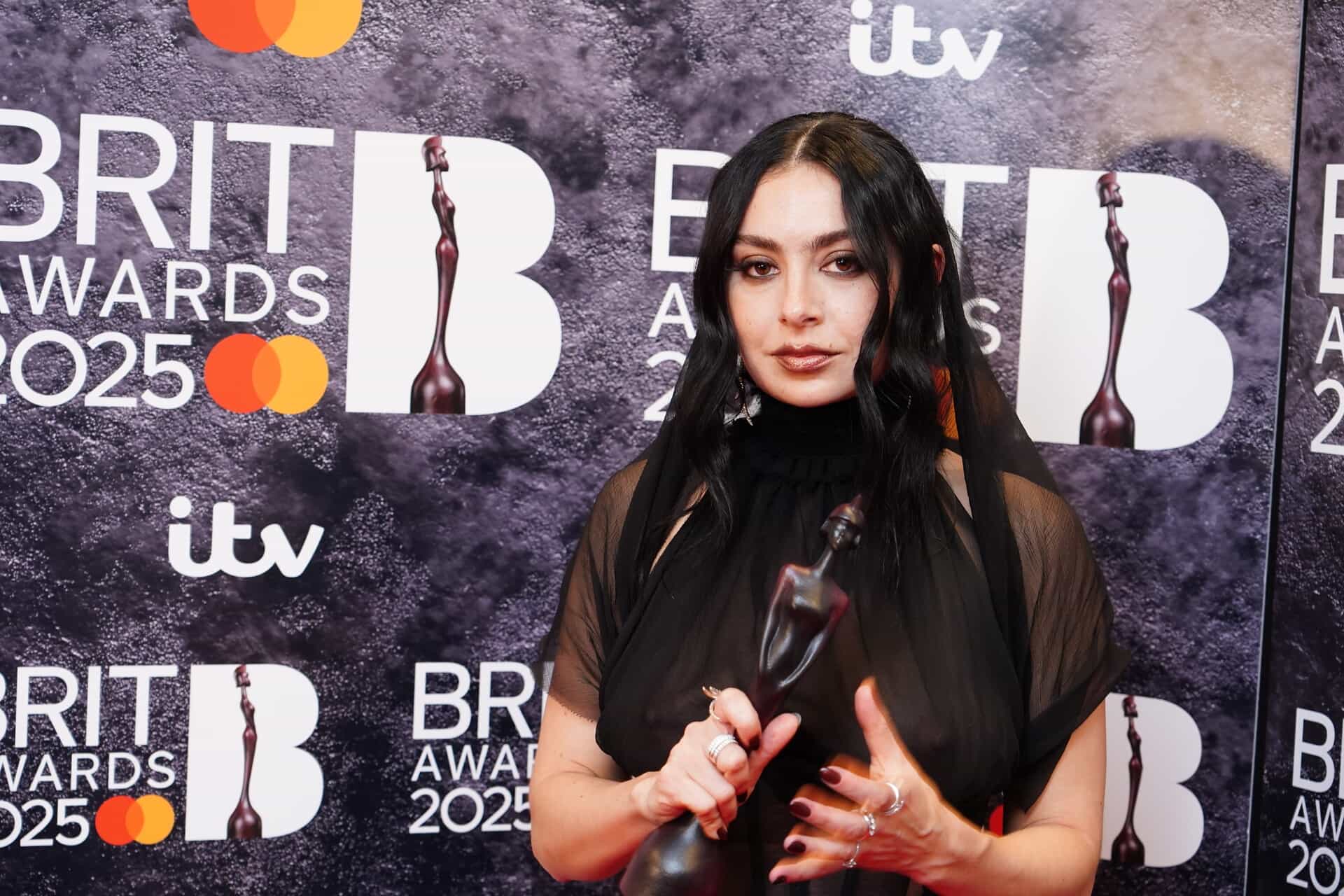 Charli XCX backstage with one of her Brit Awards (Ian West/PA).