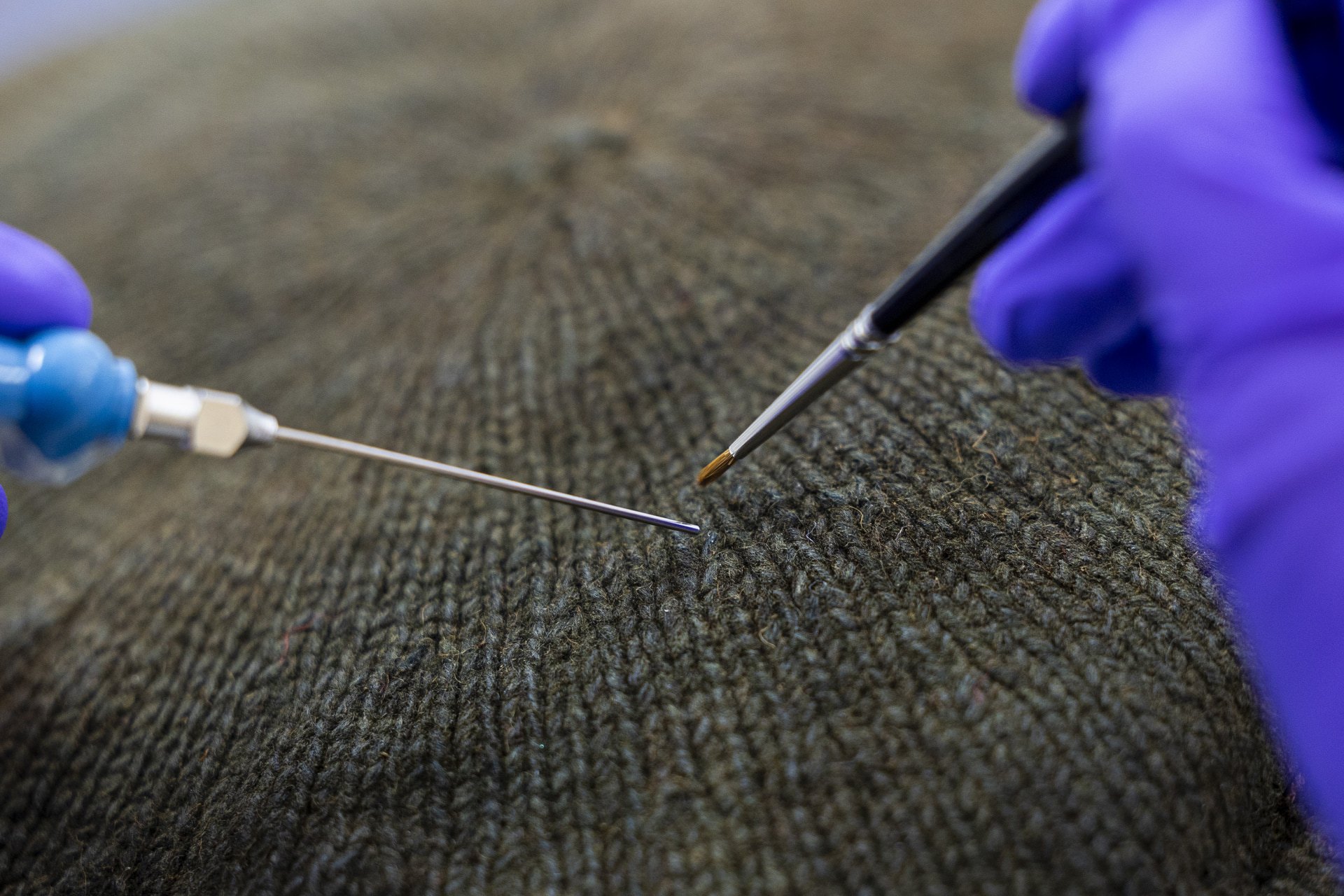 The knitted bonnet is now a brownish green colour, but analysis revealed traces of indigo.