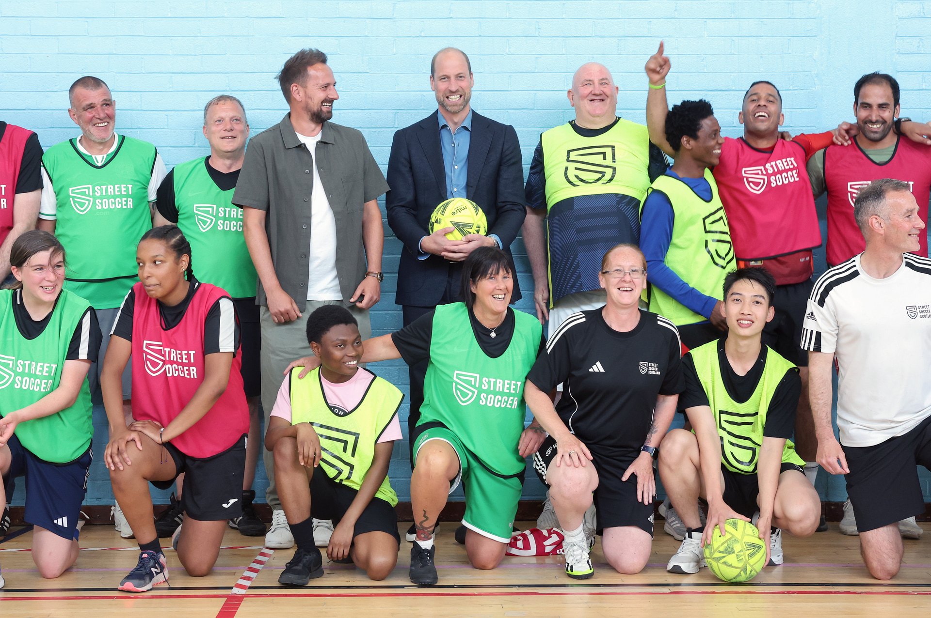 Prince William poses with football coaches and players during a visit as The Royal Foundation launches a new community impact partnership with Street Soccer Scotland at Leith Community Centre.