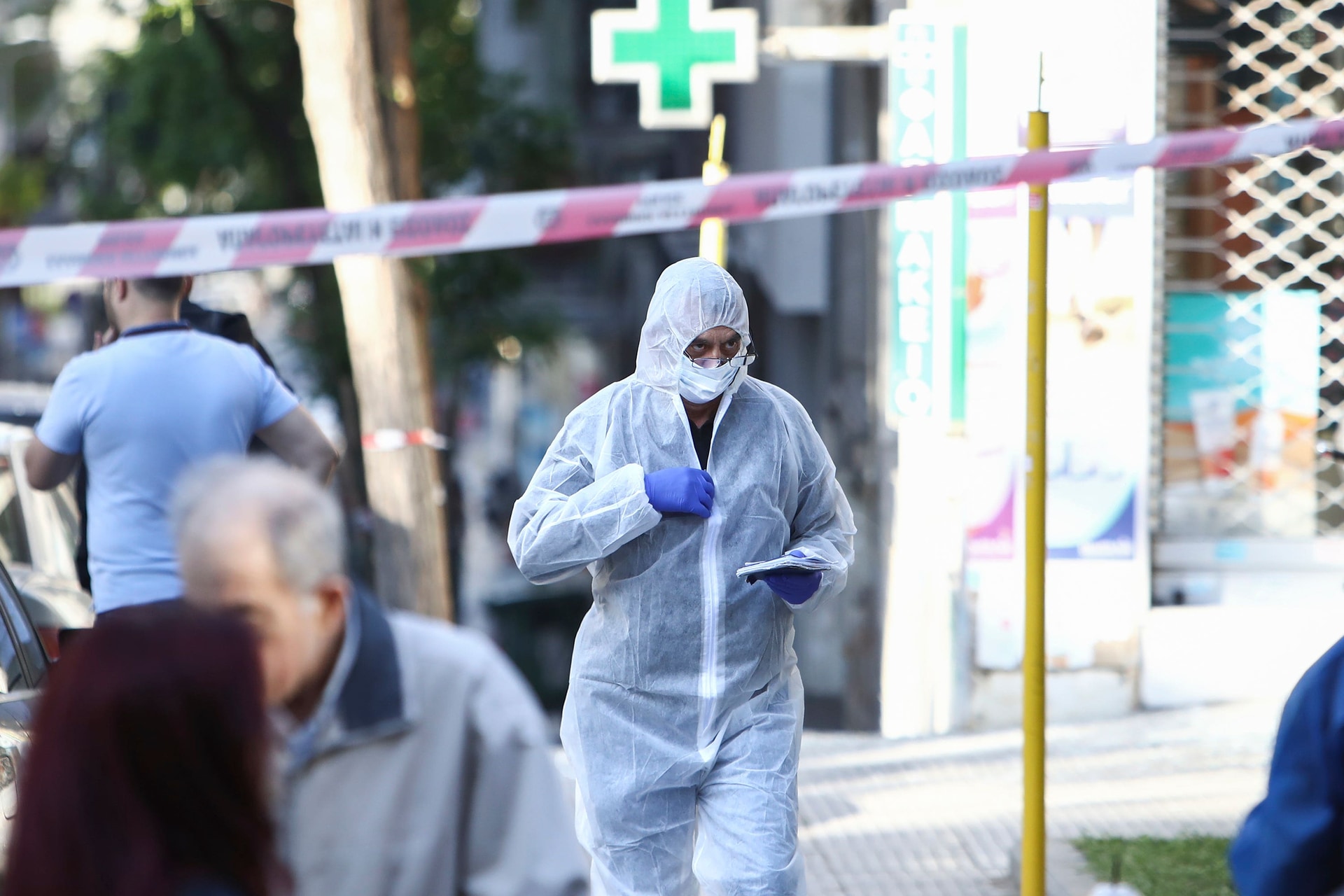 A Greek police forensic expert searches for evidence
