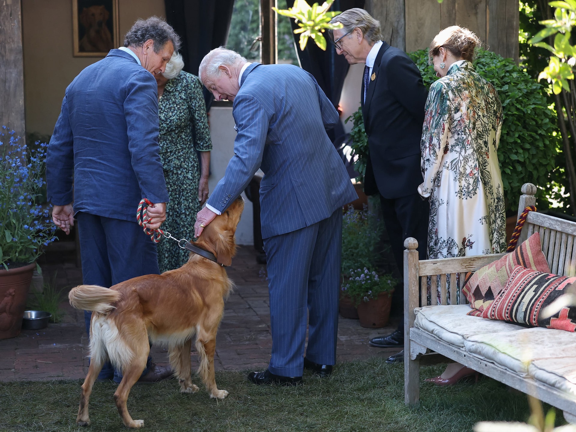 Charles pets Ned, the dog of broadcaster and gardening expert Monty Don (Toby Melville/PA).