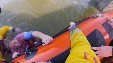 Video shows RNLI crews rescuing pair stuck in chest-deep water 