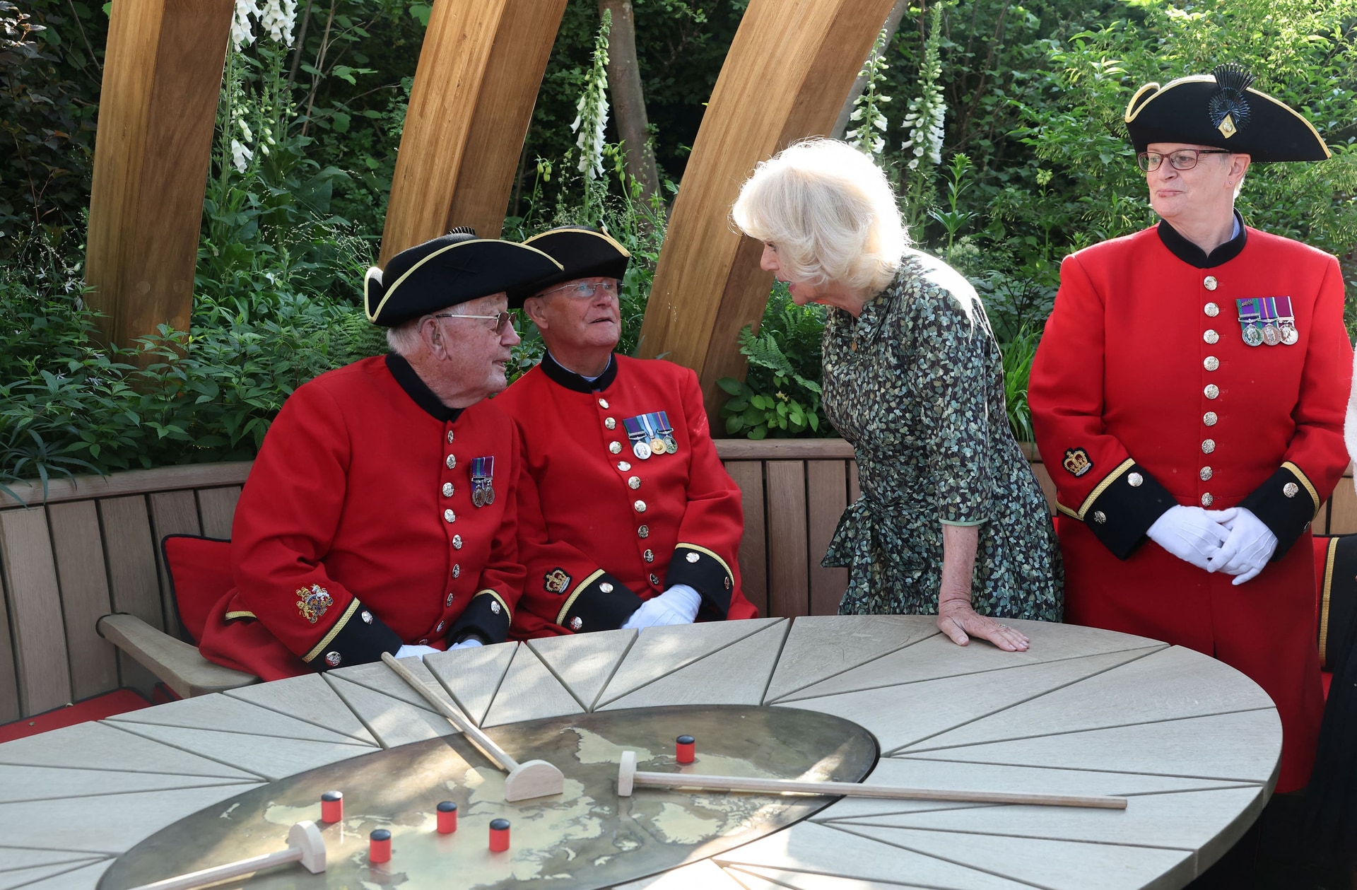The Queen speaks with Chelsea Pensioners at the London Square Chelsea Pensioners Garden (Toby Melville/PA).