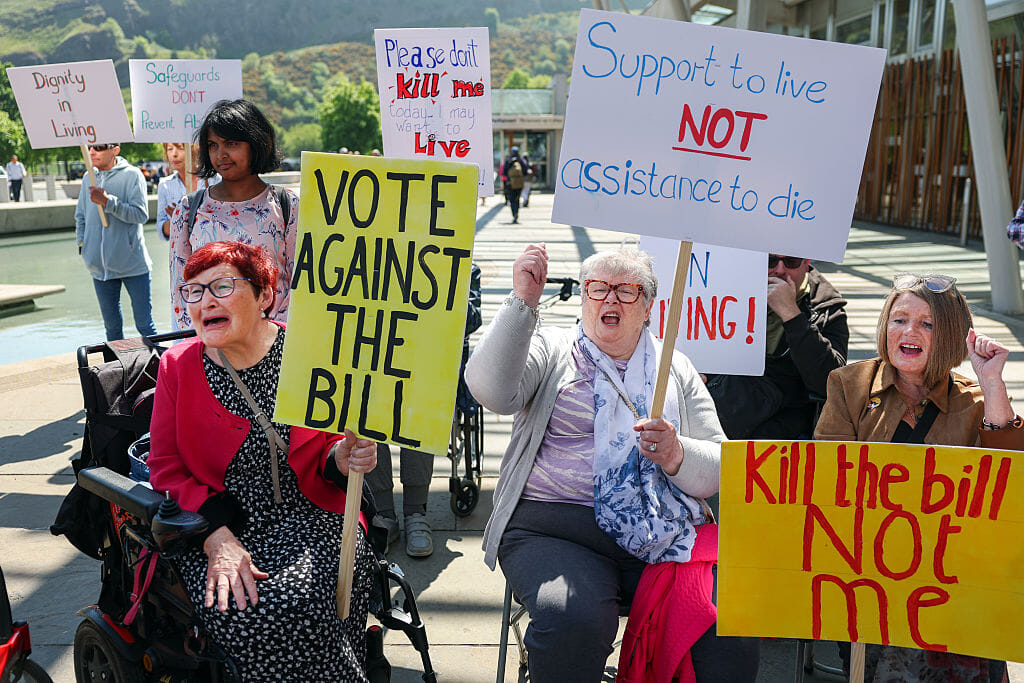 Protesters who are against the assisted dying bill gathered outside the Scottish Parliament on Tuesday.