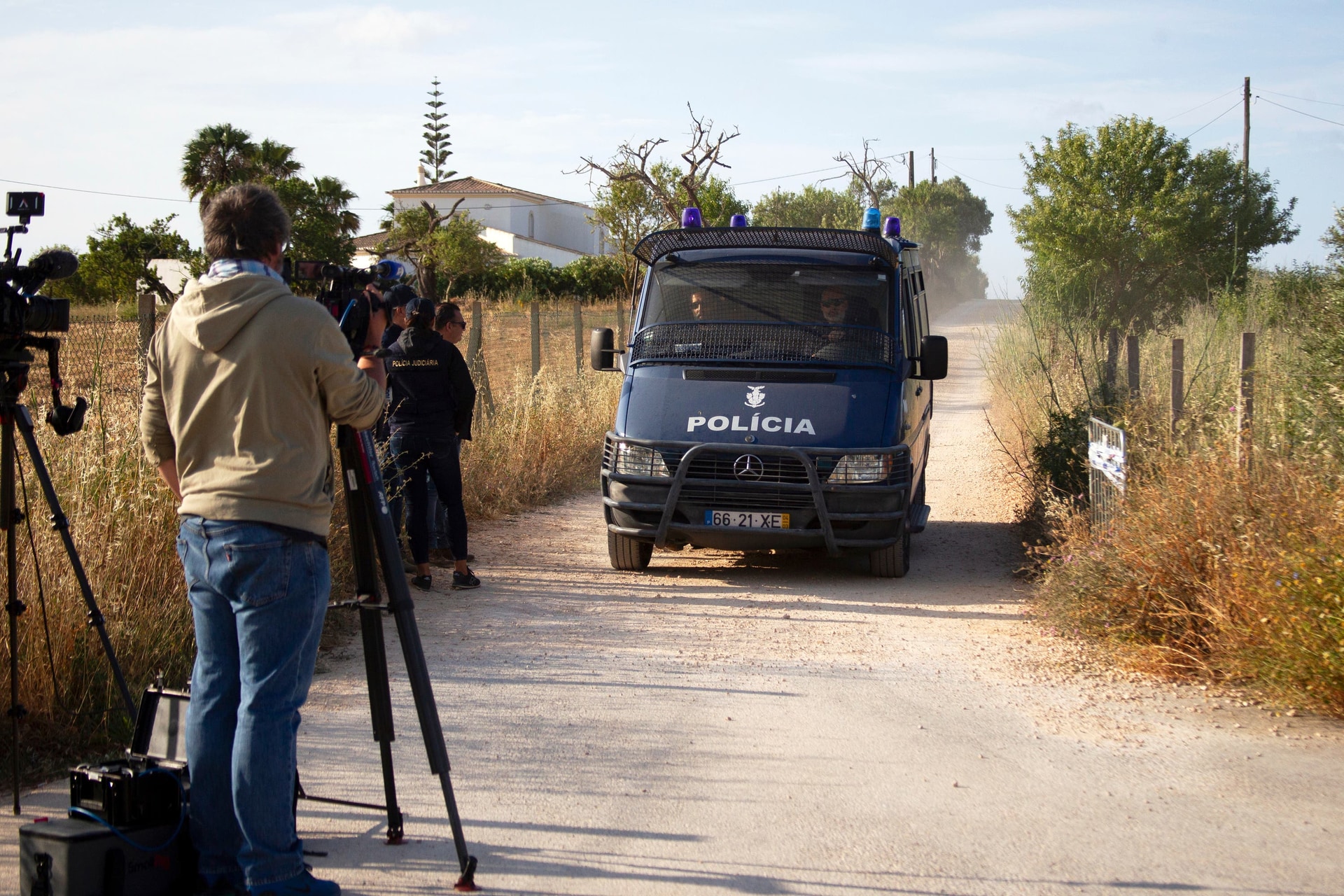 A Portuguese police van driving down a lane near where a search is taking place (Joao Matos/AP).