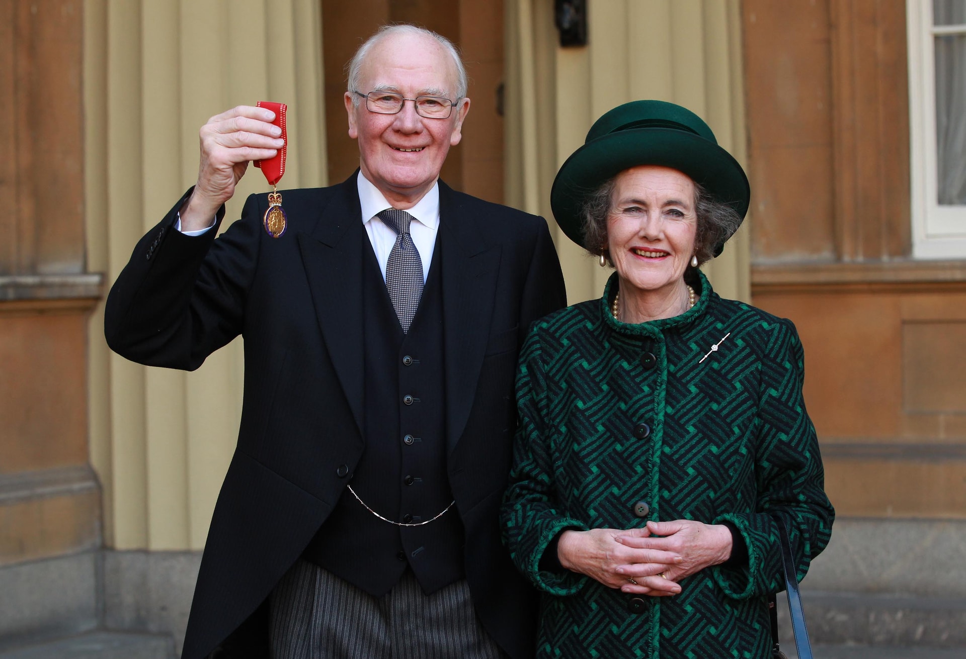 LONDON, ENGLAND - NOVEMBER 12: Sir Menzies Campbell holds his medal, with his wife Lady Elspeth Campbell, after being made a Companion of Honour by the Duke of Cambridge during an investiture ceremony at Buckingham Palace on November 12, 2013 in London, England. (Photo by Sean Dempsey - WPA Pool/Getty Images)