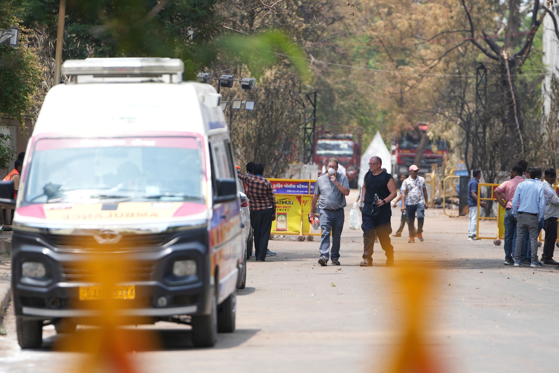 Investigators come out after visiting the Air India plane crash site in Ahmedabad, India.