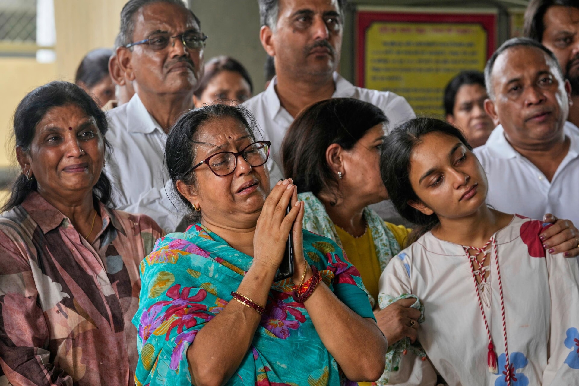 Relatives grieve as they attend the funeral of Shubh Modi and his sister Shagun Modi, both victims of the Air India plane crash, at a crematorium in Ahmedabad, India