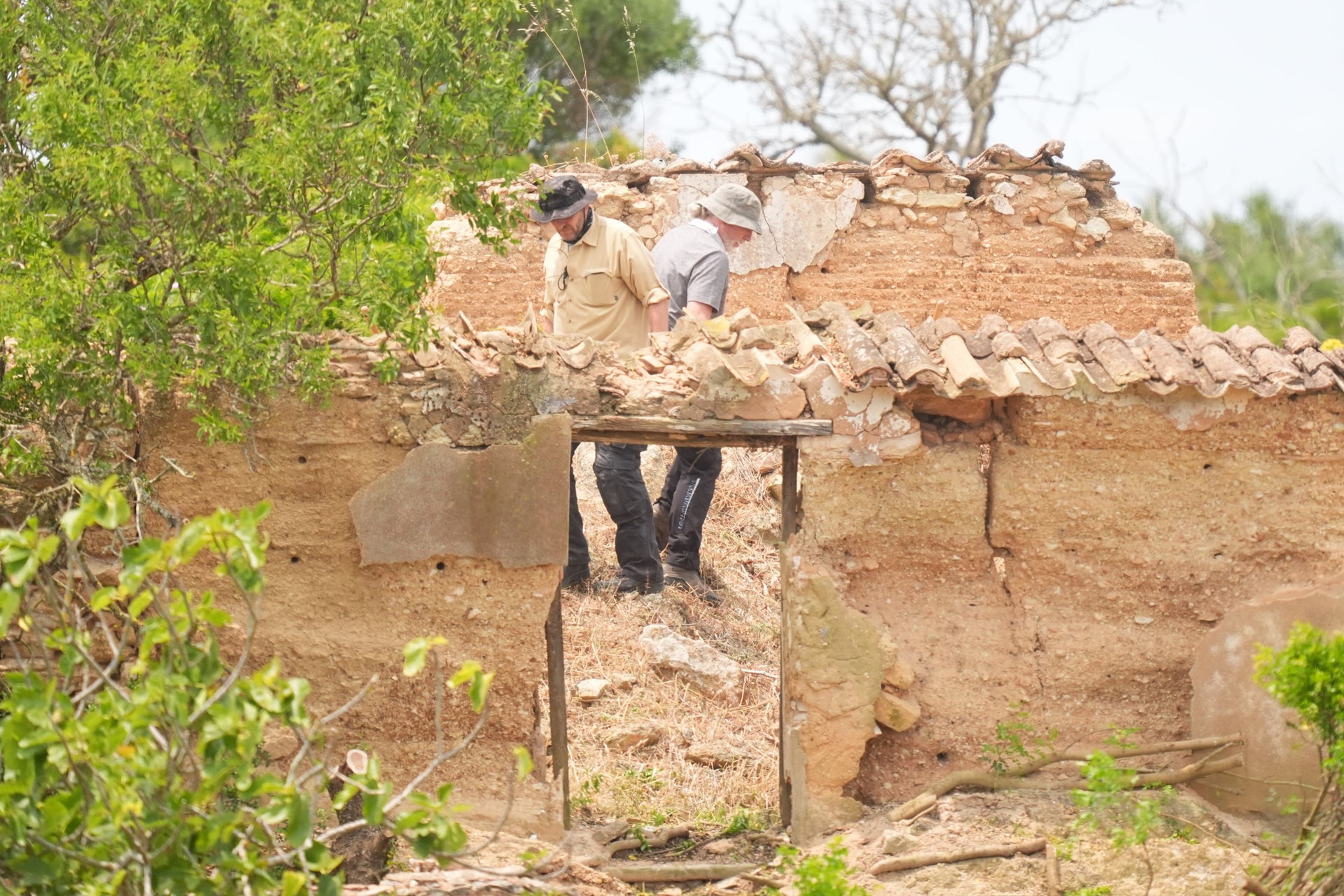 Search teams look through a derelict and abandoned property to the west of Praia da Luz (James Manning/PA).