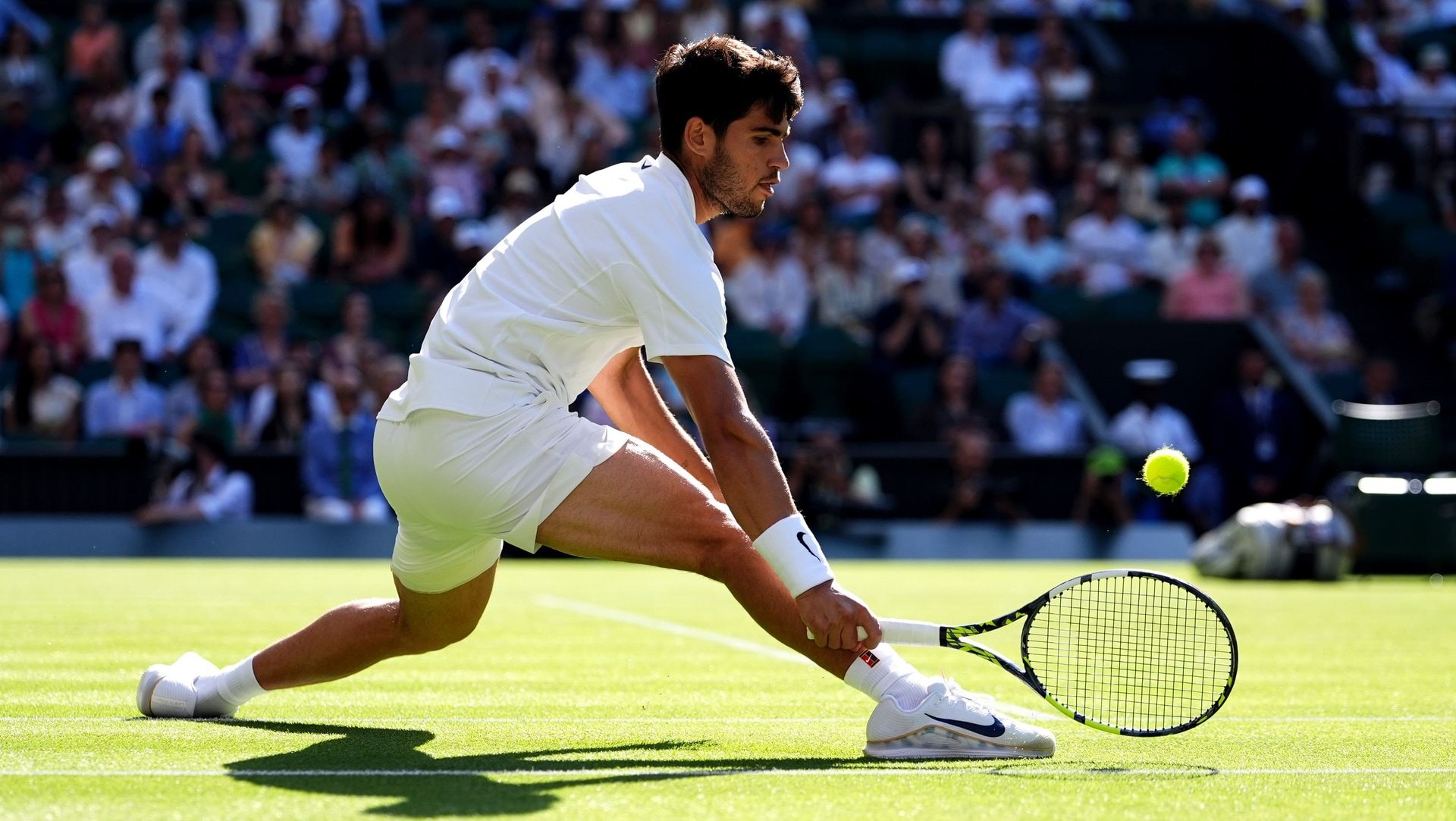 Carlos Alcaraz slides into a forehand.
