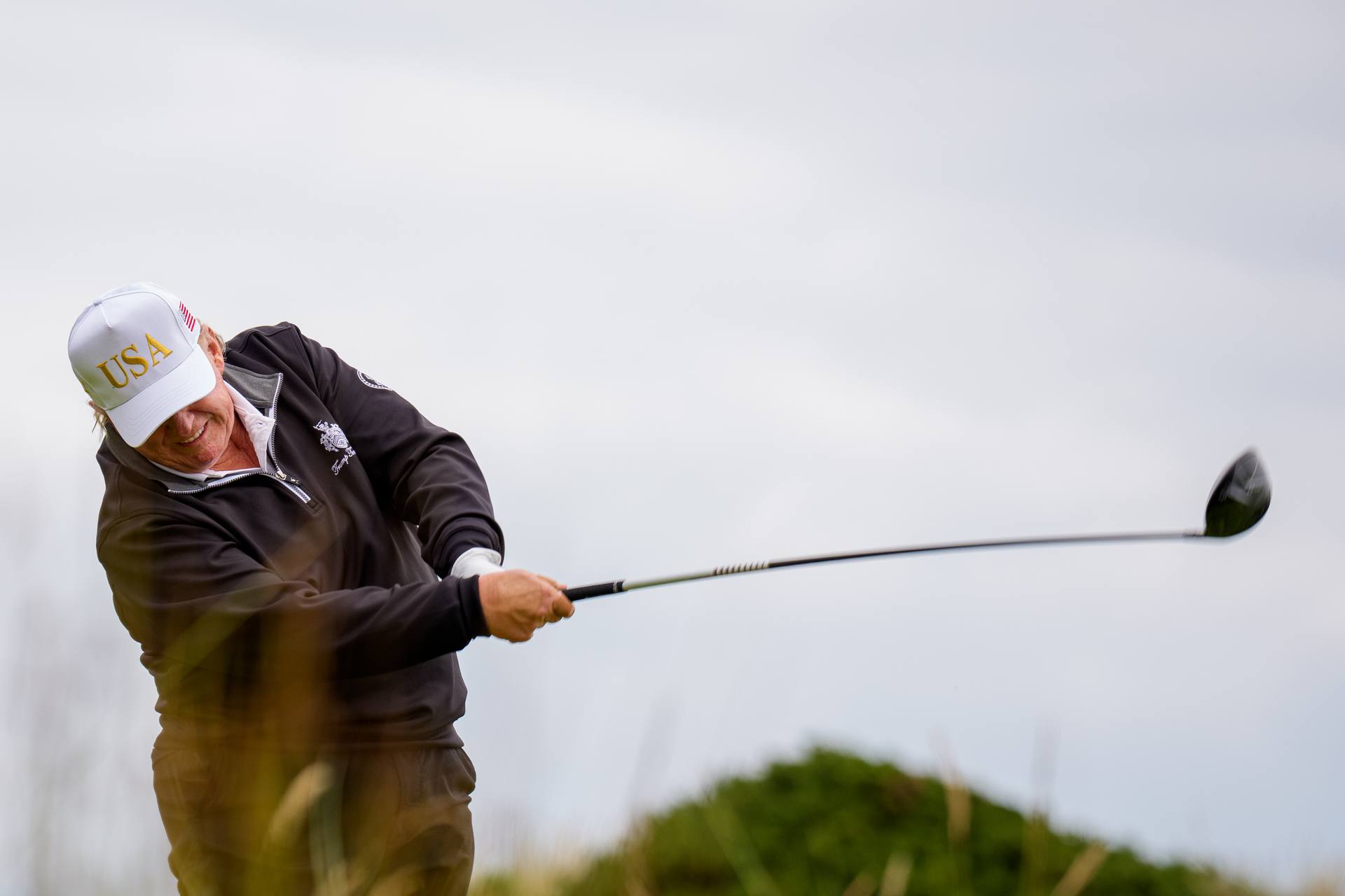 Donald Trump tees off at a new 18-hole course at Trump International Golf Links on July 29.