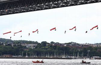 Greenpeace activists abseil from Forth Road Bridge to stop gas tanker