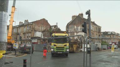 Homes evacuated after fire-damaged tenement collapses
