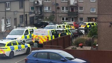 Man and woman arrested after armed police raid Fife home