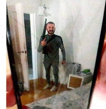 Photos of Gary Strachen armed with the shotgun that he had held to a woman's head helped convict him of assault and possession of a firearm.
