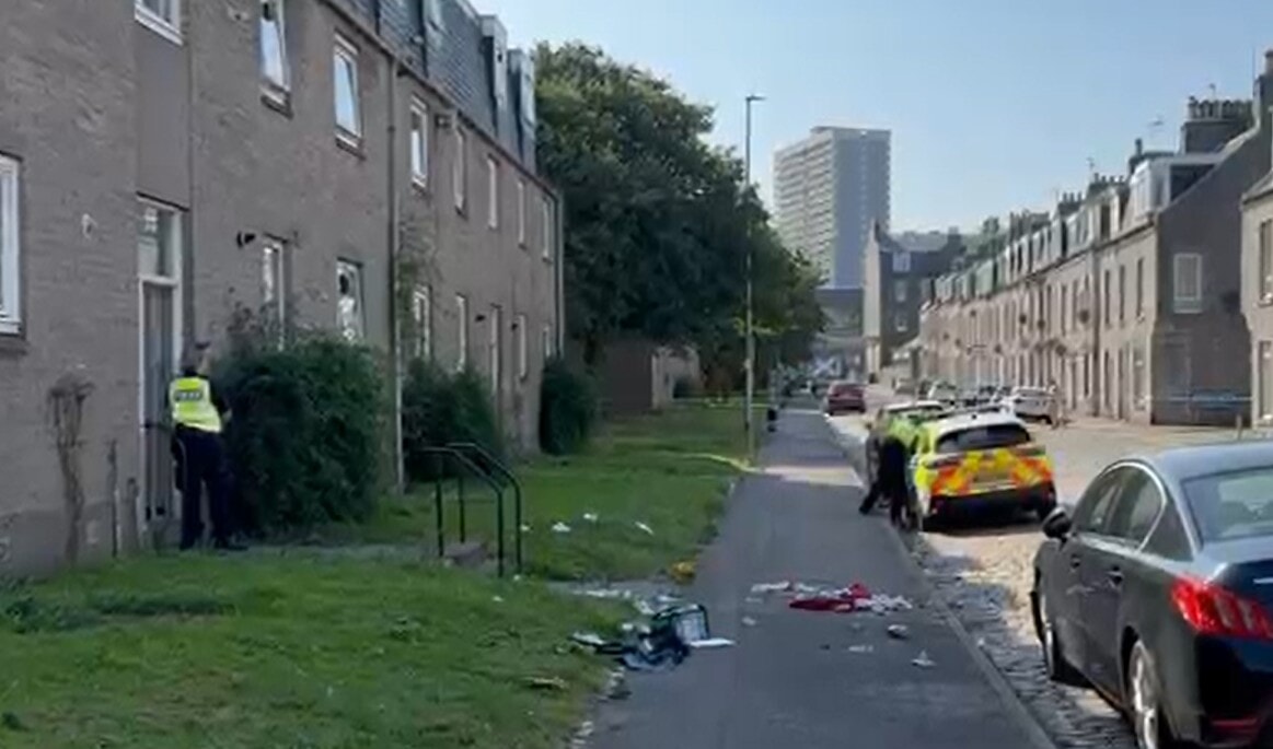 Officers have been seen standing at the entrance to a blcok off flats.