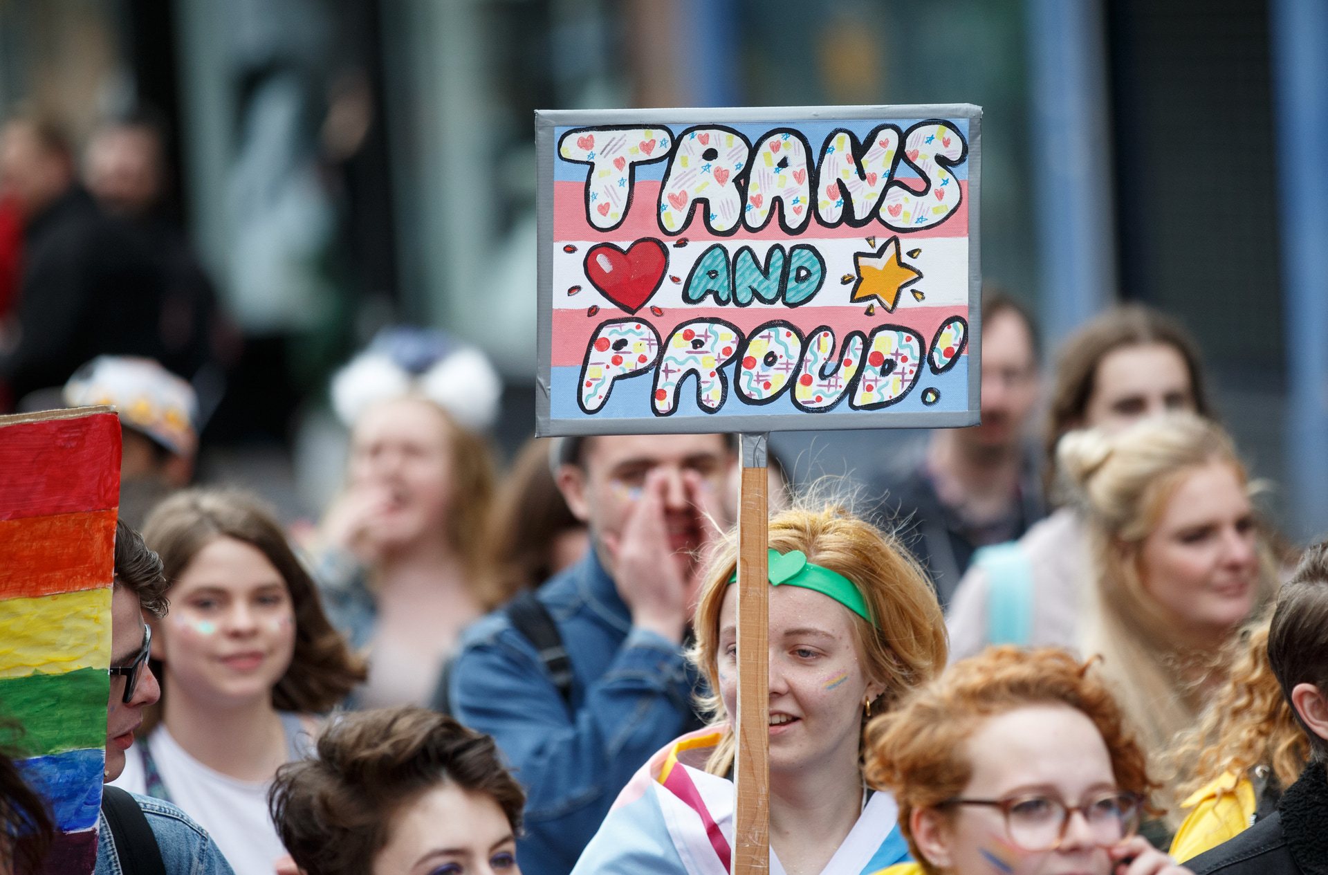 A participant holds a sign saying 'Trans and Proud' during the Glasgow Pride march on August 19, 2017.