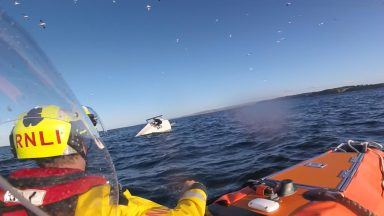 Search for capsized dinghy with two sailors on board after distress call 