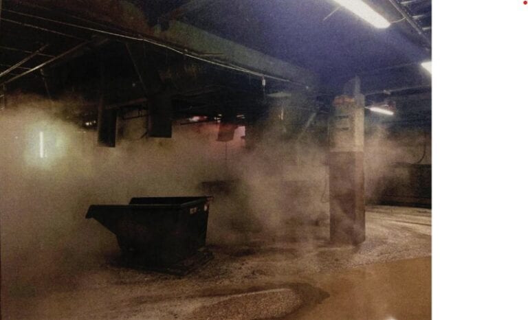 The basement of the site and the skips being used to collect waste product.