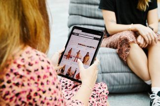 Online fashion retailer Asos lowers sales outlook as customers continue to cutback on spending