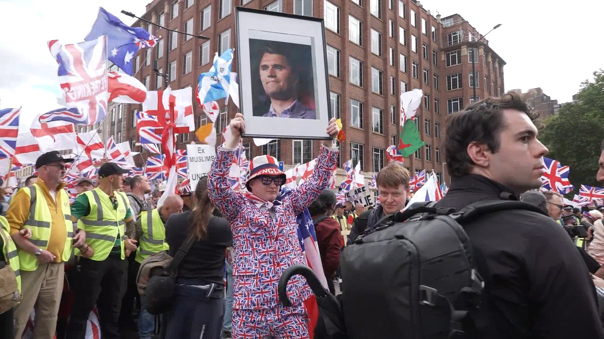 A person holds a portrait of Charlie Kirk during the Tommy Robinson-led Unite the Kingdom march and rally in central London. Picture date: Saturday September 13, 2025.