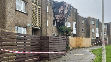 Roof torn off block of flats in Cumbernauld during Storm Amy