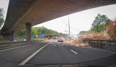 Tractor driver dies after trailer load of timber crashes onto motorway in Glasgow