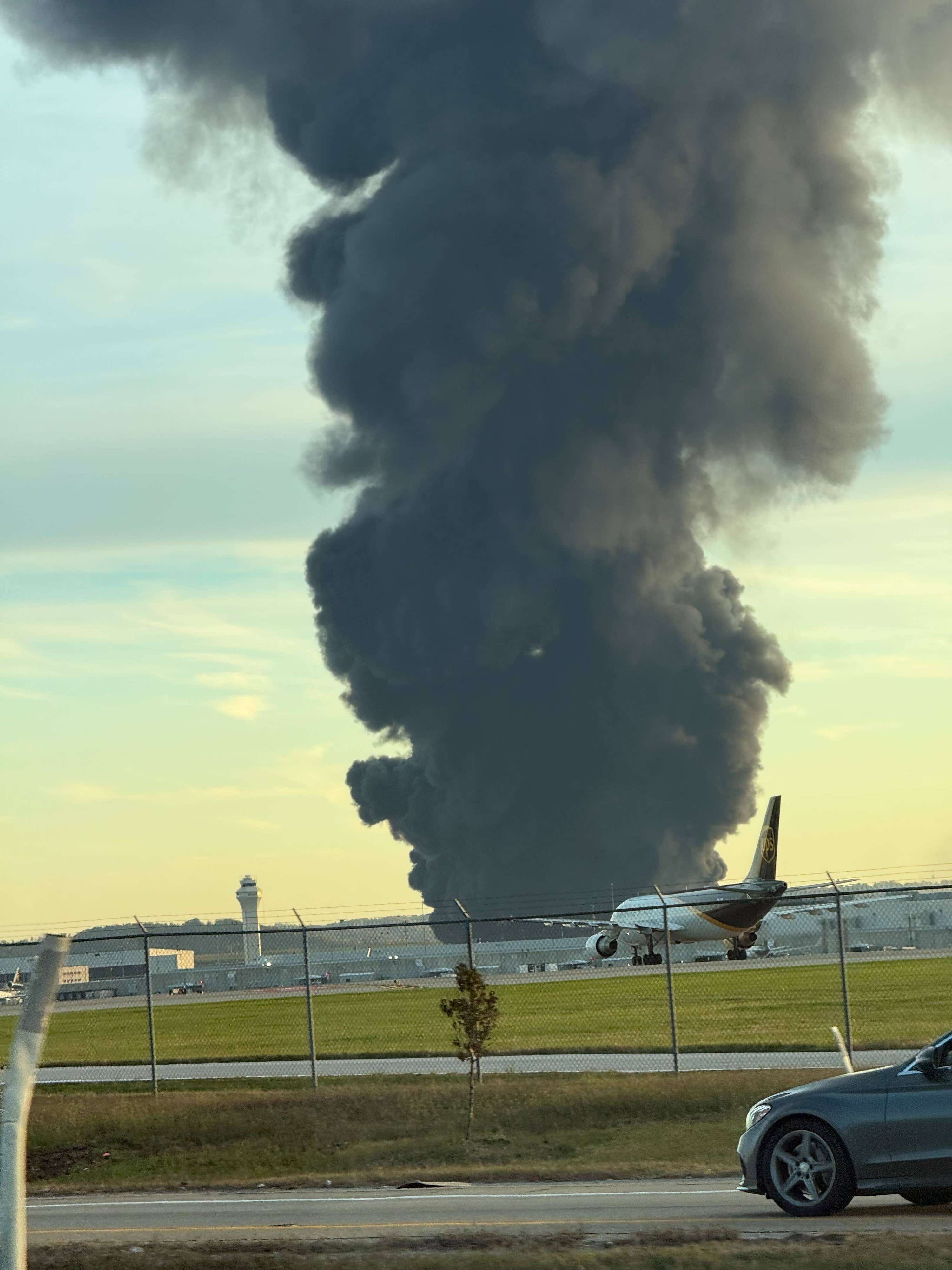 This photo provided by Brad Harvey shows thick, black smoke rising near Louisville International Airport, Kentucky.