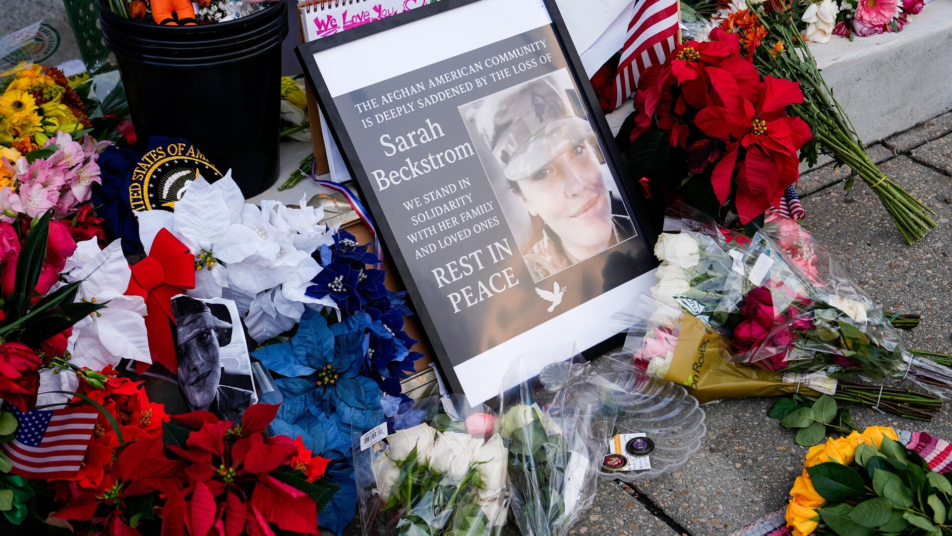 Tributes were left near a photograph of Specialist Sarah Beckstrom at a makeshift memorial near the site of the shooting in Washington.