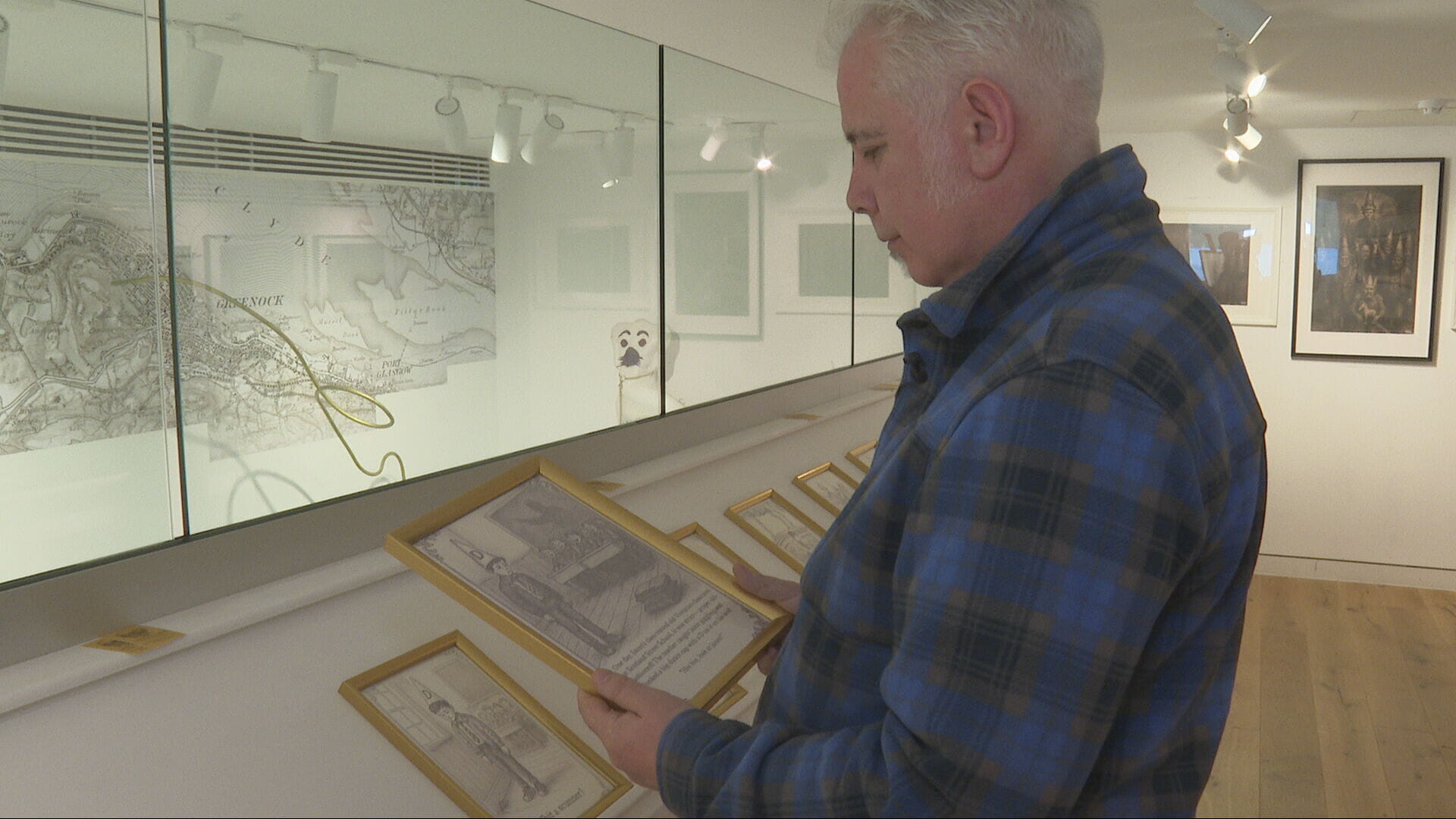 Jason examines some of his drawings at the exhibition