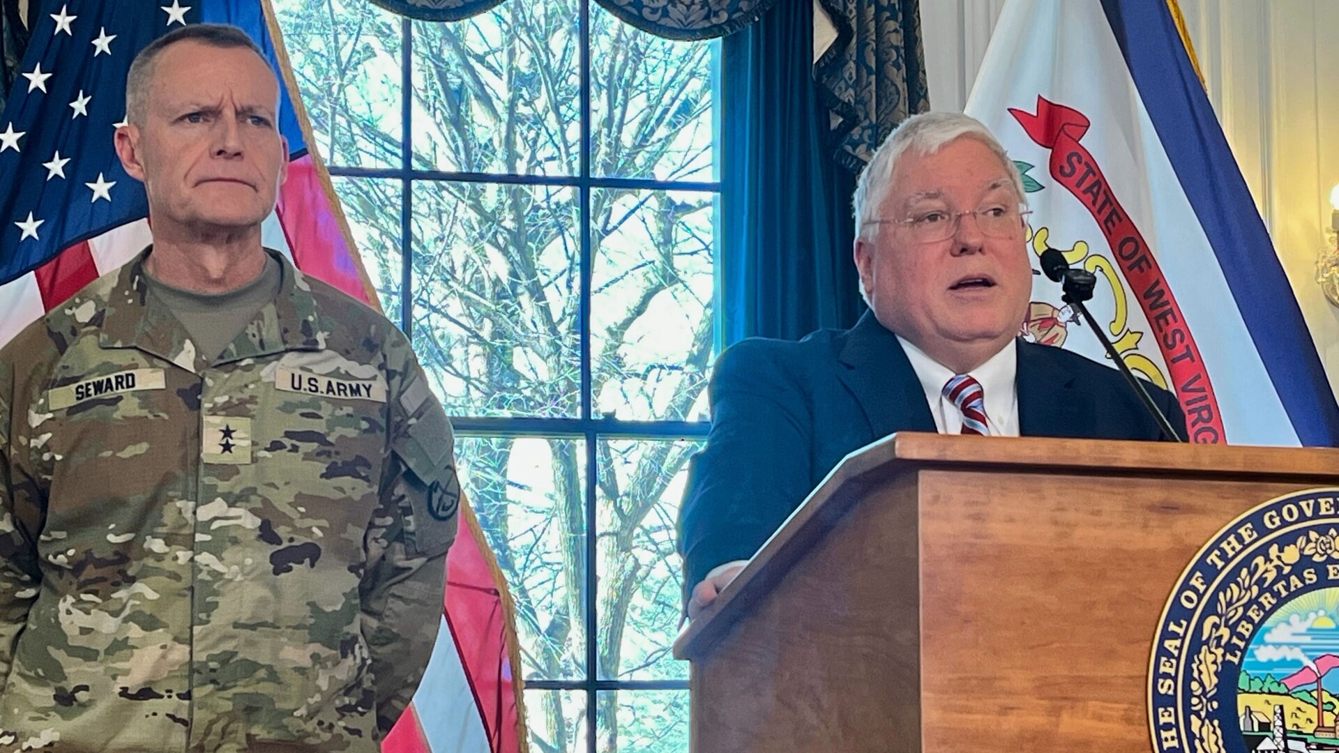 West Virginia Governor Patrick Morrisey, right, speaks while West Virginia National Guard Major General James Seward looks on during a news conference on Monday.