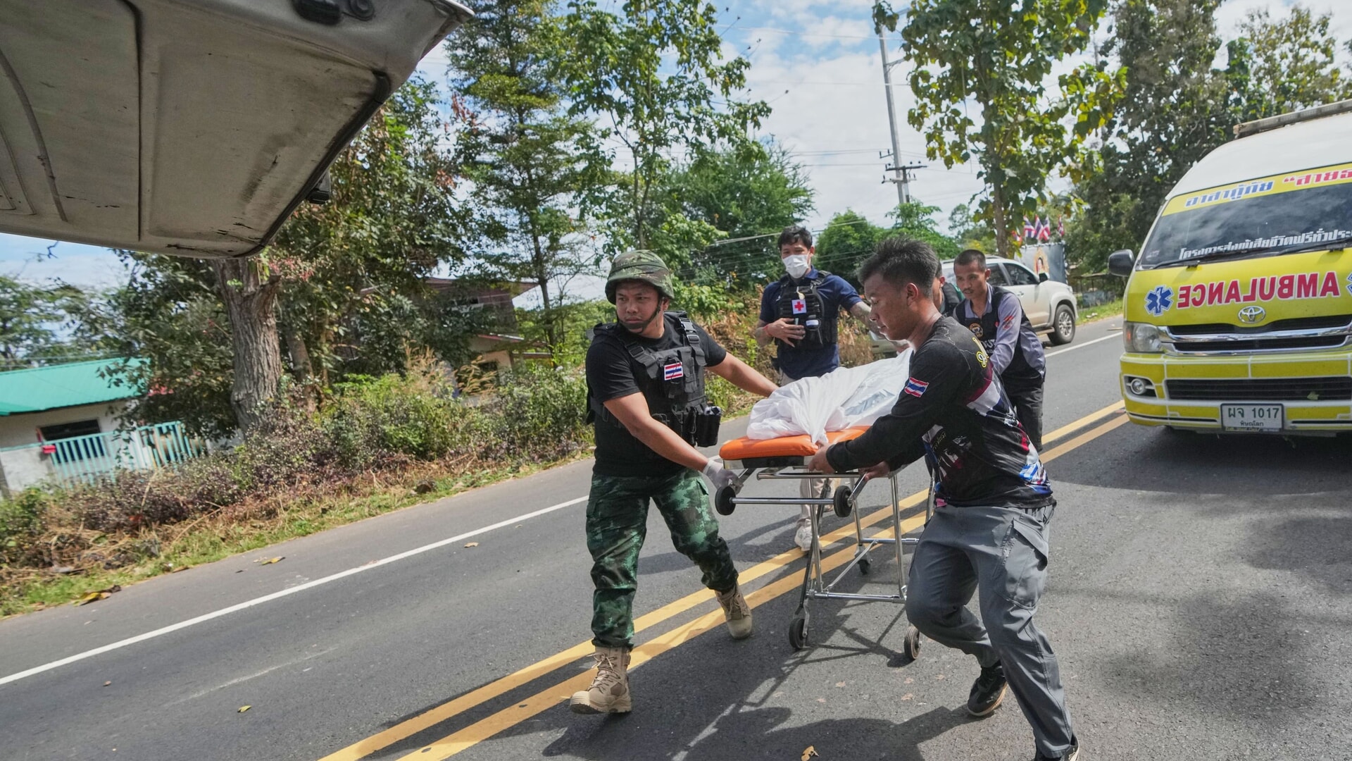 Thai rescue team members move a body into a vehicle after a Cambodian artillery strike in Sisaket province.