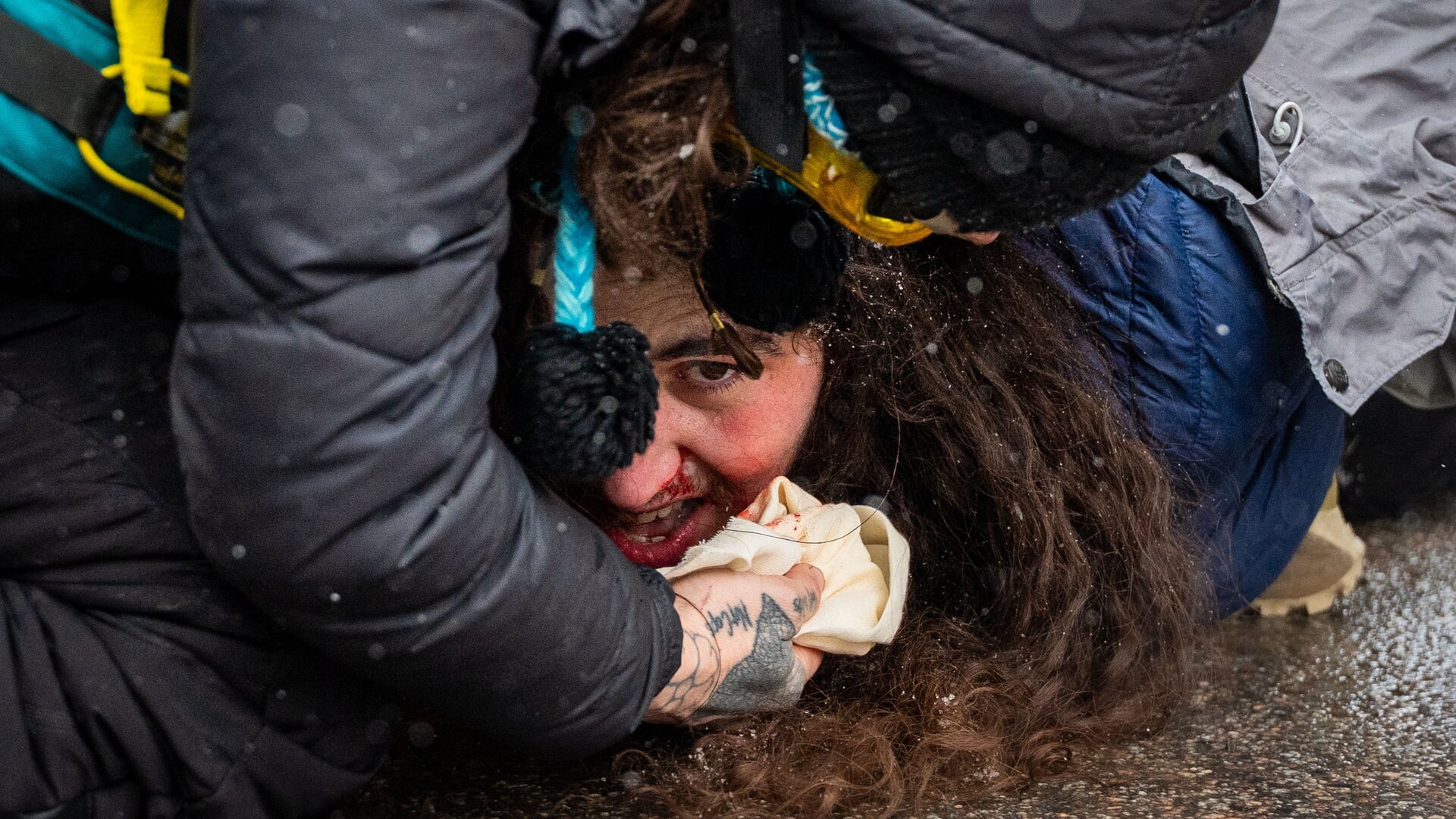Federal agents detain a person.