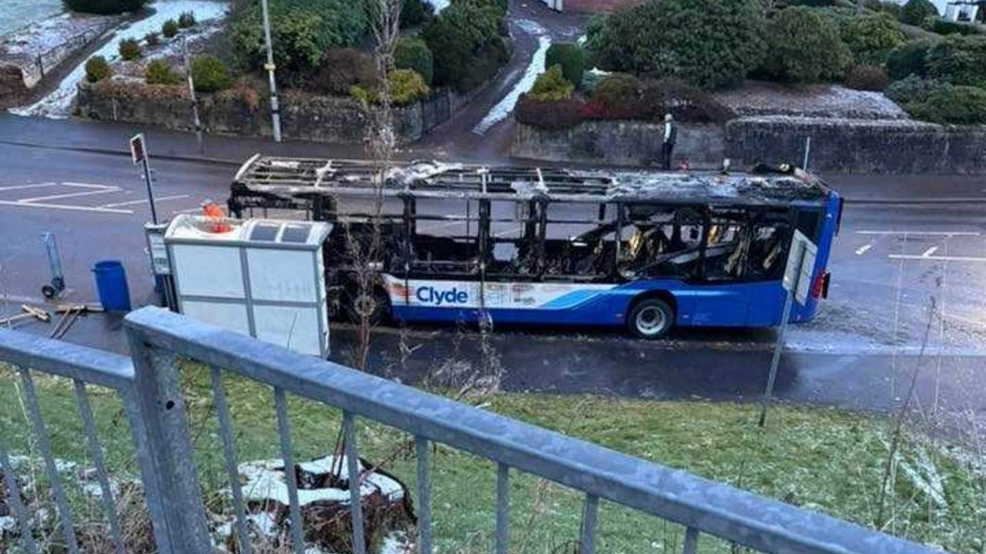 Fire crews are tackling a blaze after a bus was engulfed in flames with a road in Greenock closed.