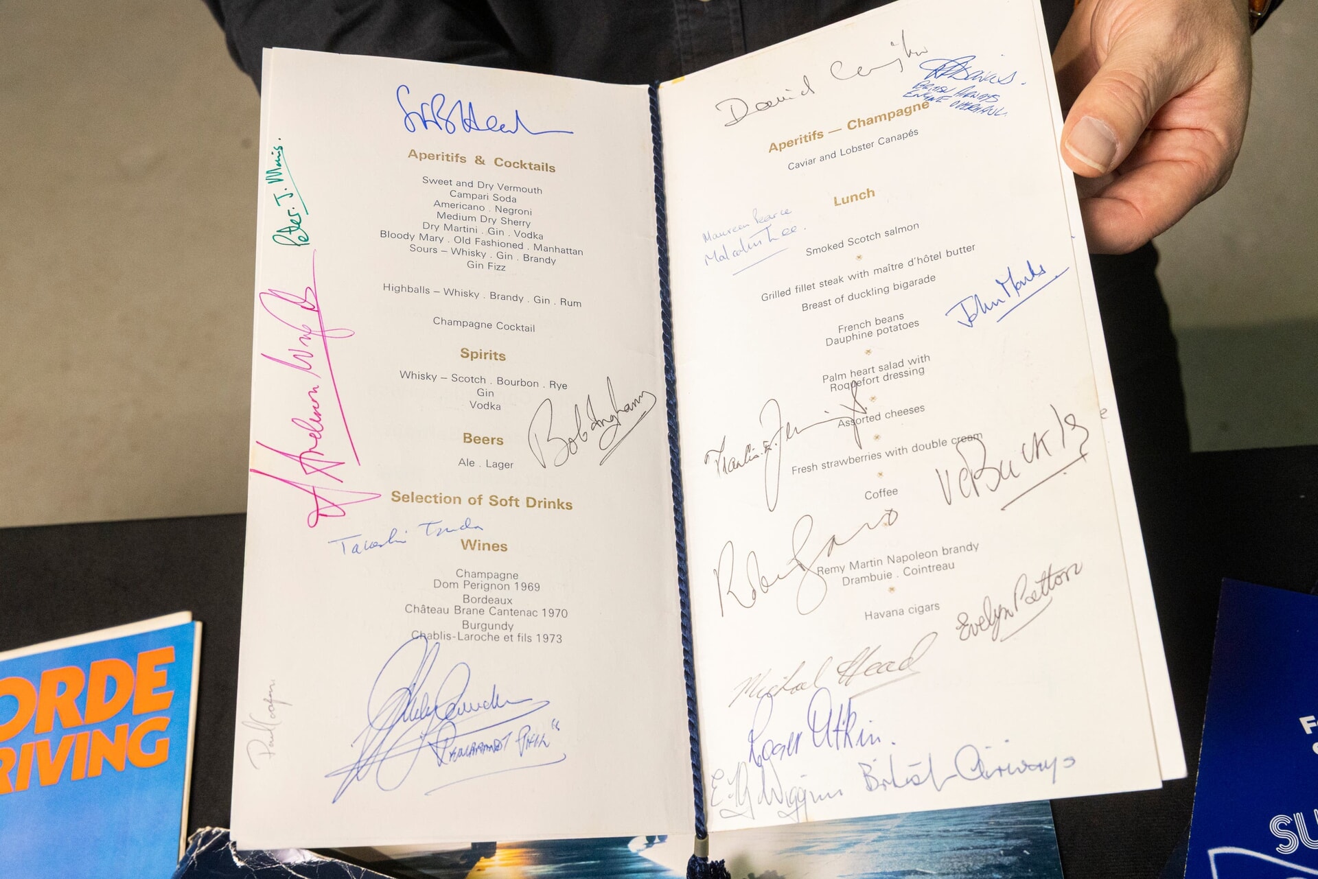 Mementoes include a menu signed by passengers on the flight.