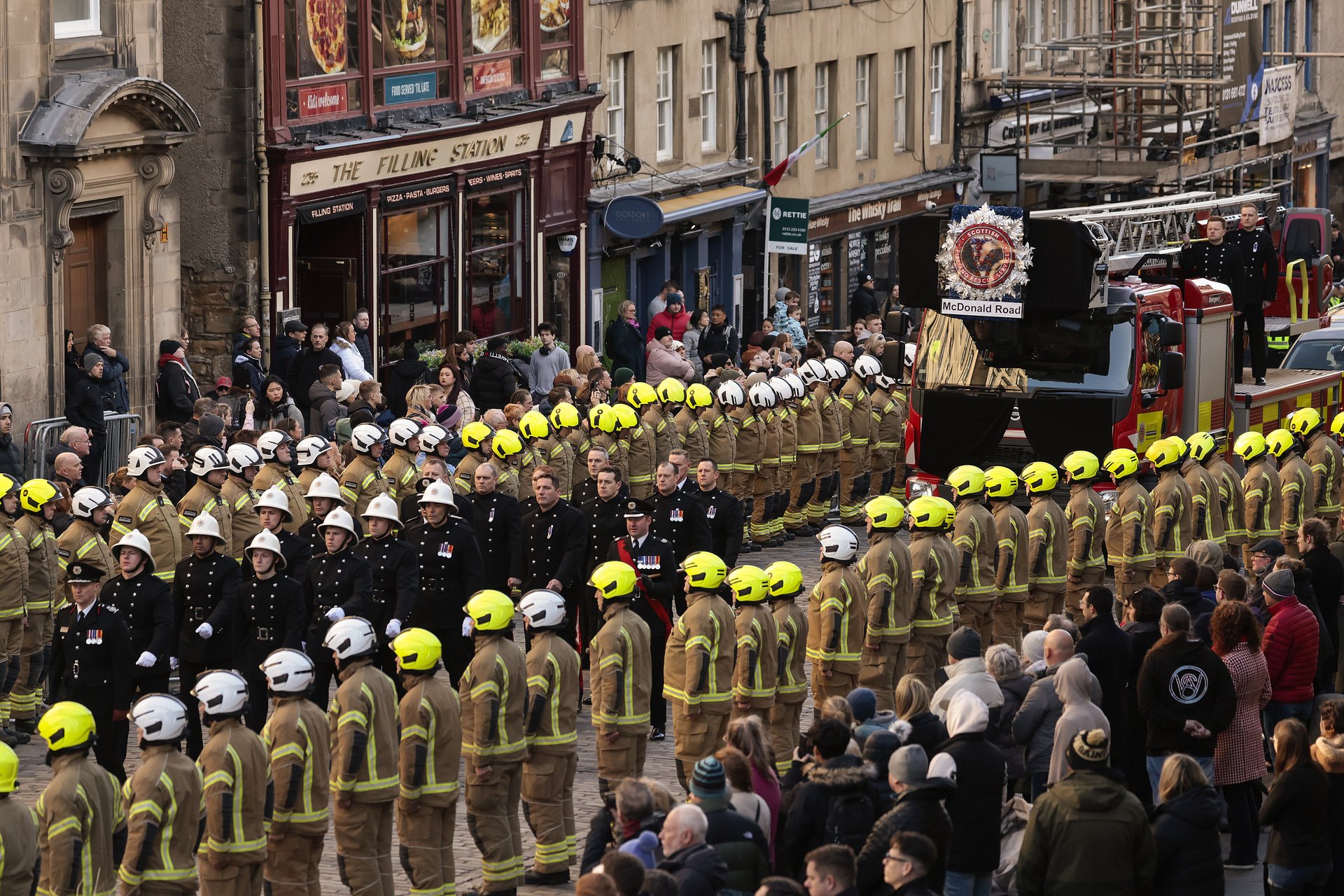 Members of the Scottish Fire and Rescue Service line the streets to pay their respects during the funeral of their colleague who died in the Jenners blaze at St Giles' Cathedral on February 17, 2023.