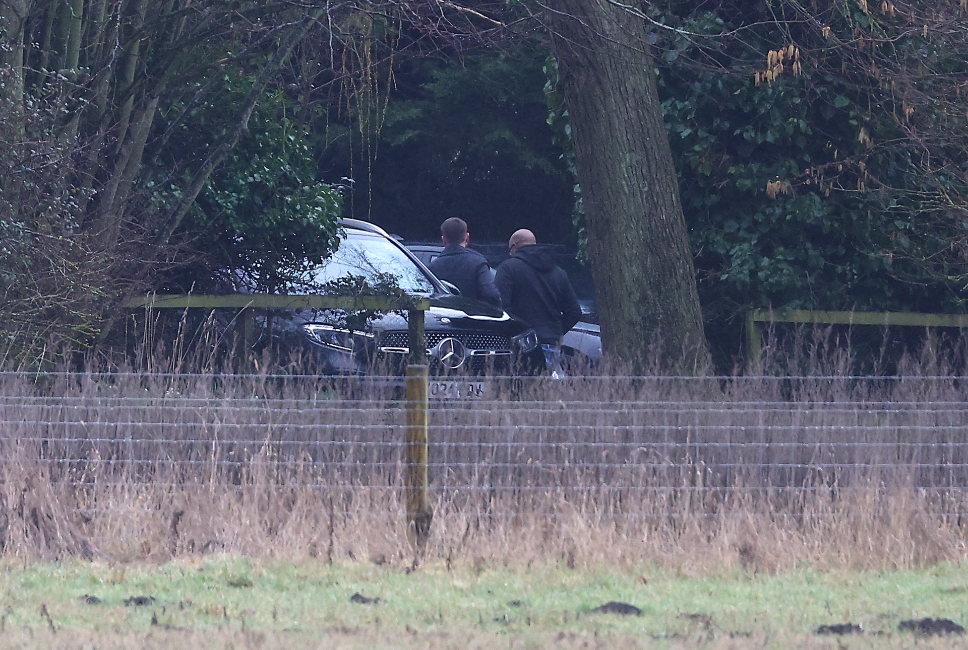 Men step out of an unmarked car at the home of Andrew Mountbatten-Windsor on February 19 in Sandringham, Norfolk.