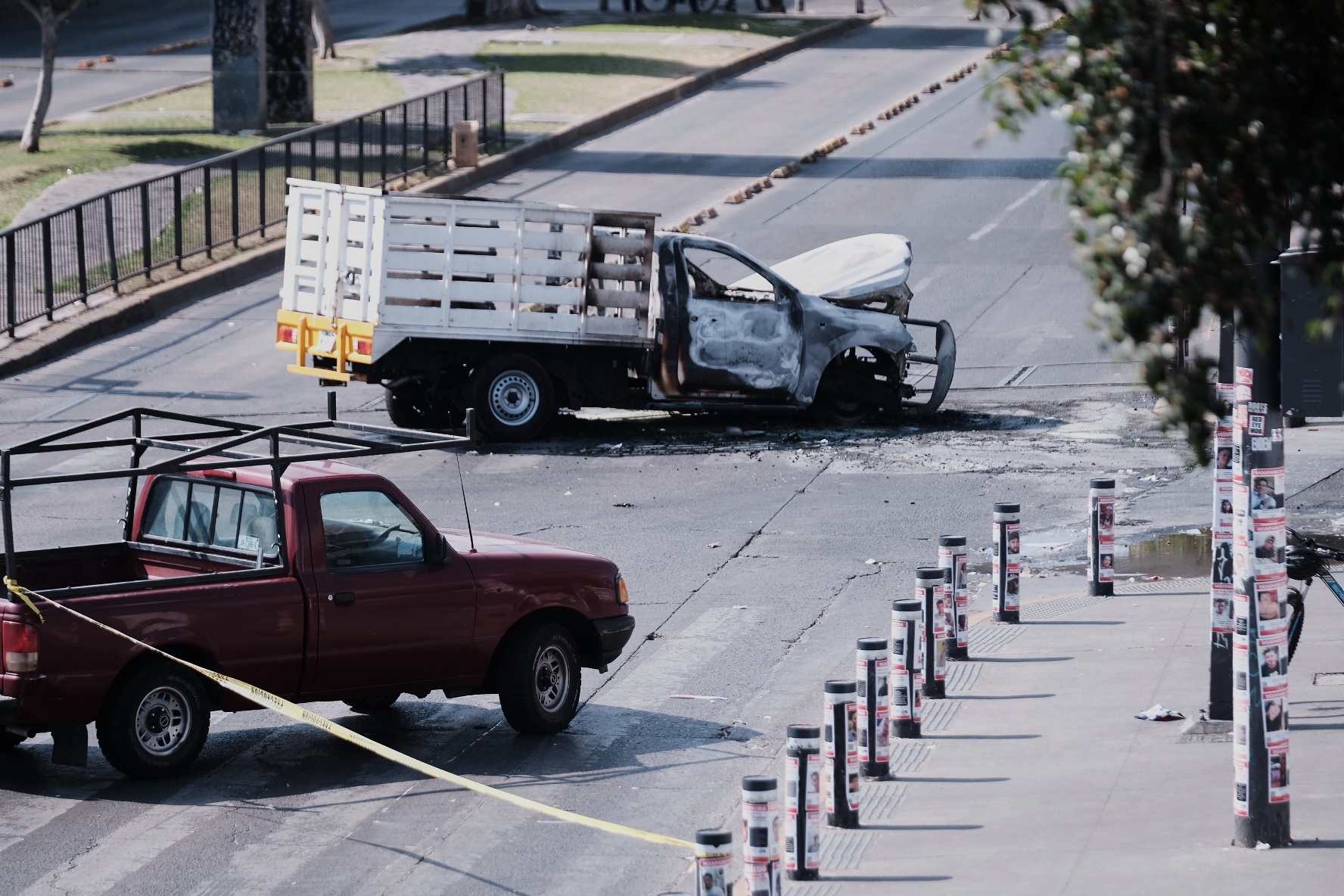 A vehicle sits charred after being set on fire, on a road in Guadalajara, Jalisco state, following the death of ‘El Chapo