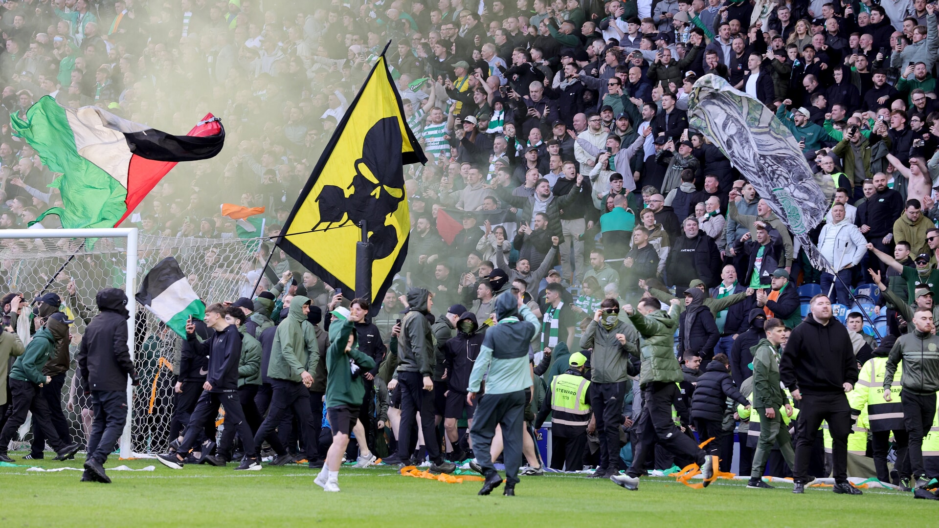 Celtic fans spill onto the pitch following their teams win in a penalty shoot out after the Scottish Gas Men's Scottish Cup quarter-final match at Ibrox Stadium, Glasgow. Picture date: Sunday March 8, 2026.