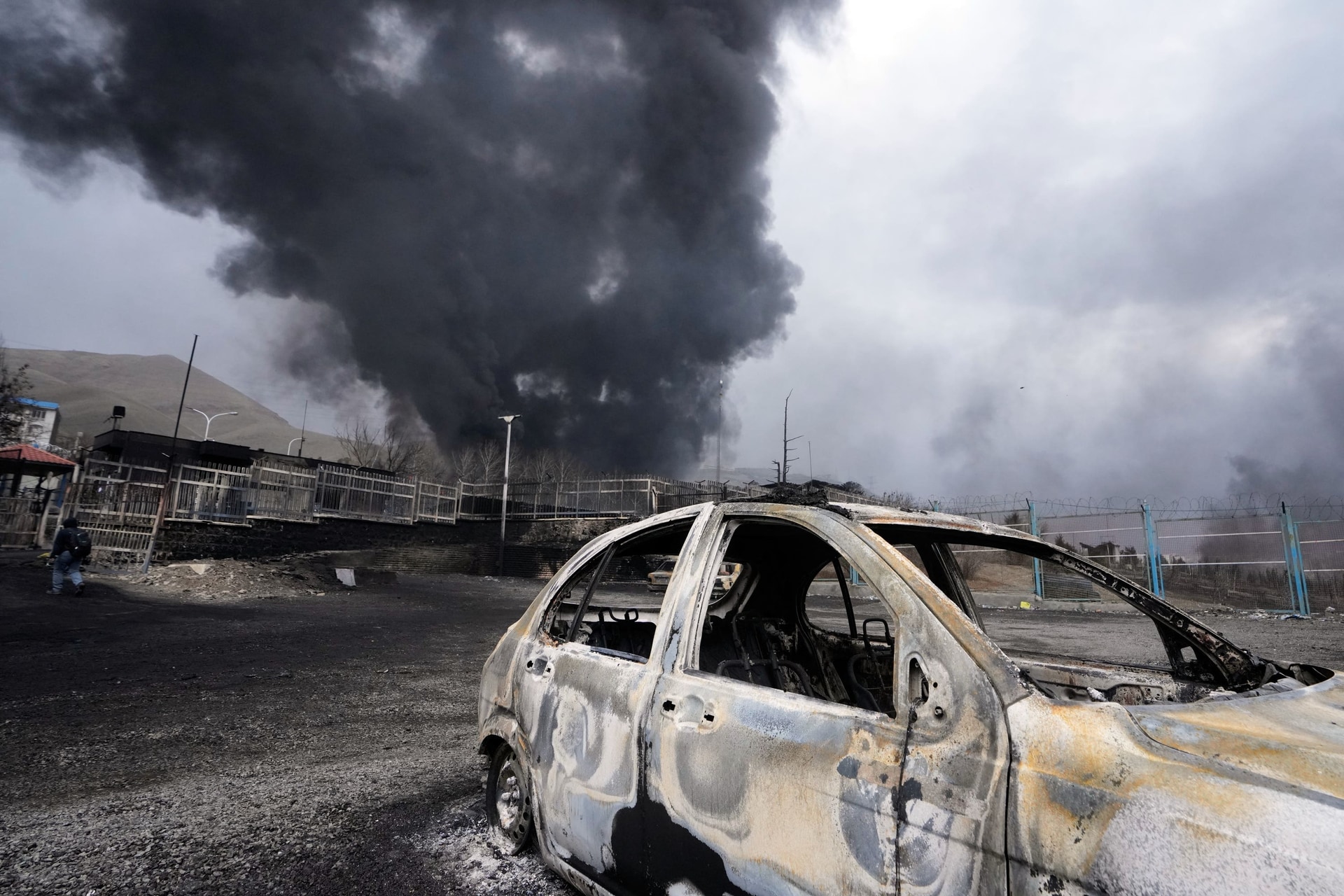 A thick plume of smoke rises from an oil storage facility hit by a US-Israeli strike in Tehran, Iran