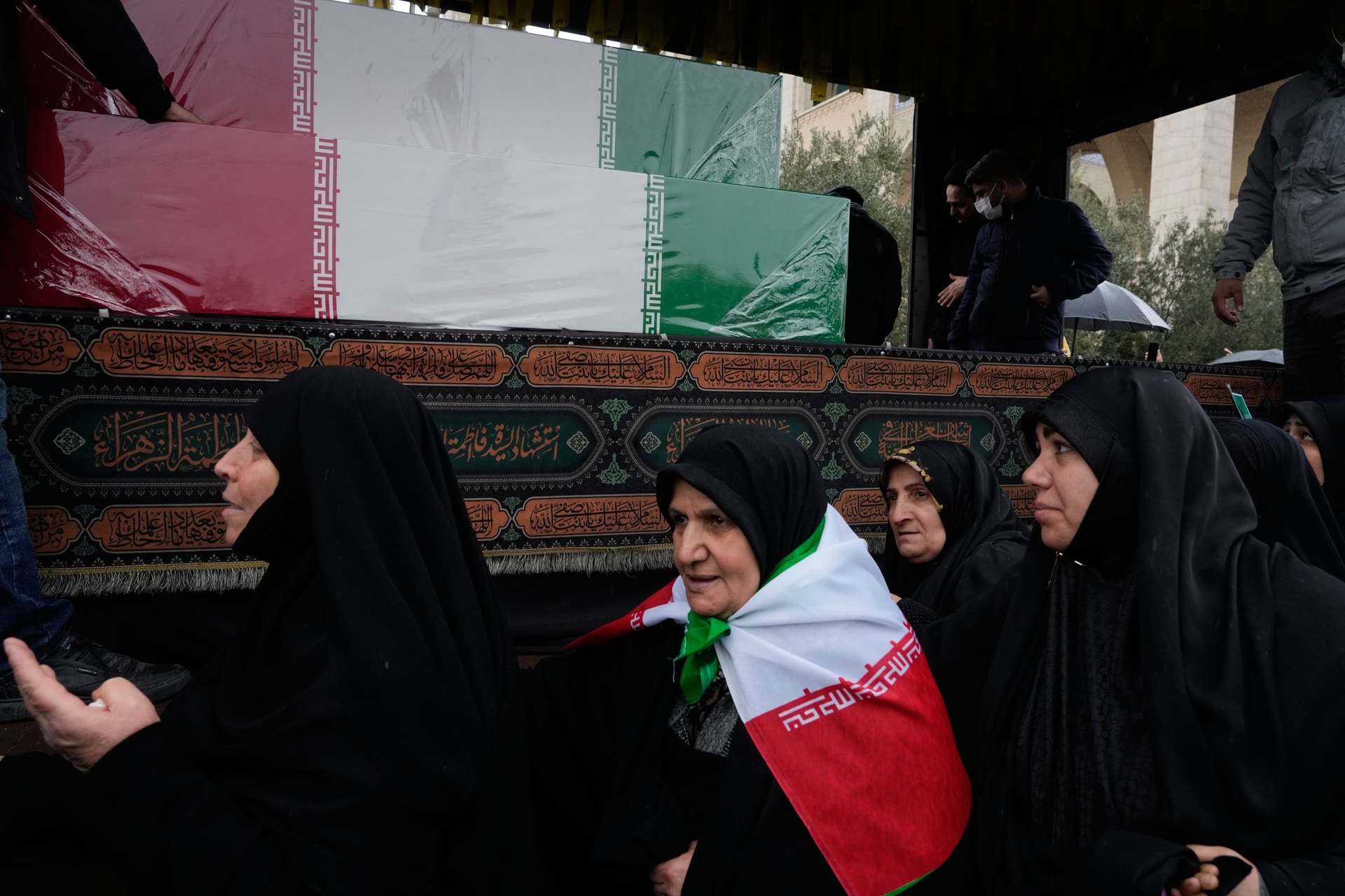 Women follow a truck carrying the flag-draped coffins of Iran’s intelligence minister, Esmail Khatib (Vahid Salemi/AP)