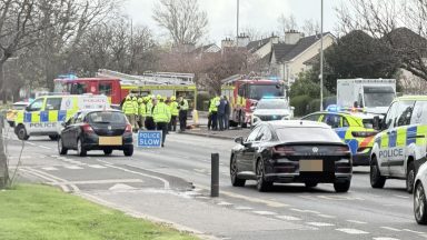 Glasgow road blocked after crash as emergency services remain in attendance