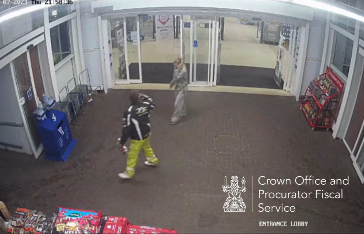 Lee Milne walking ahead of Kimberley Bruce while leaving a supermarket at Kingsway, Dundee on July 27, 2023.