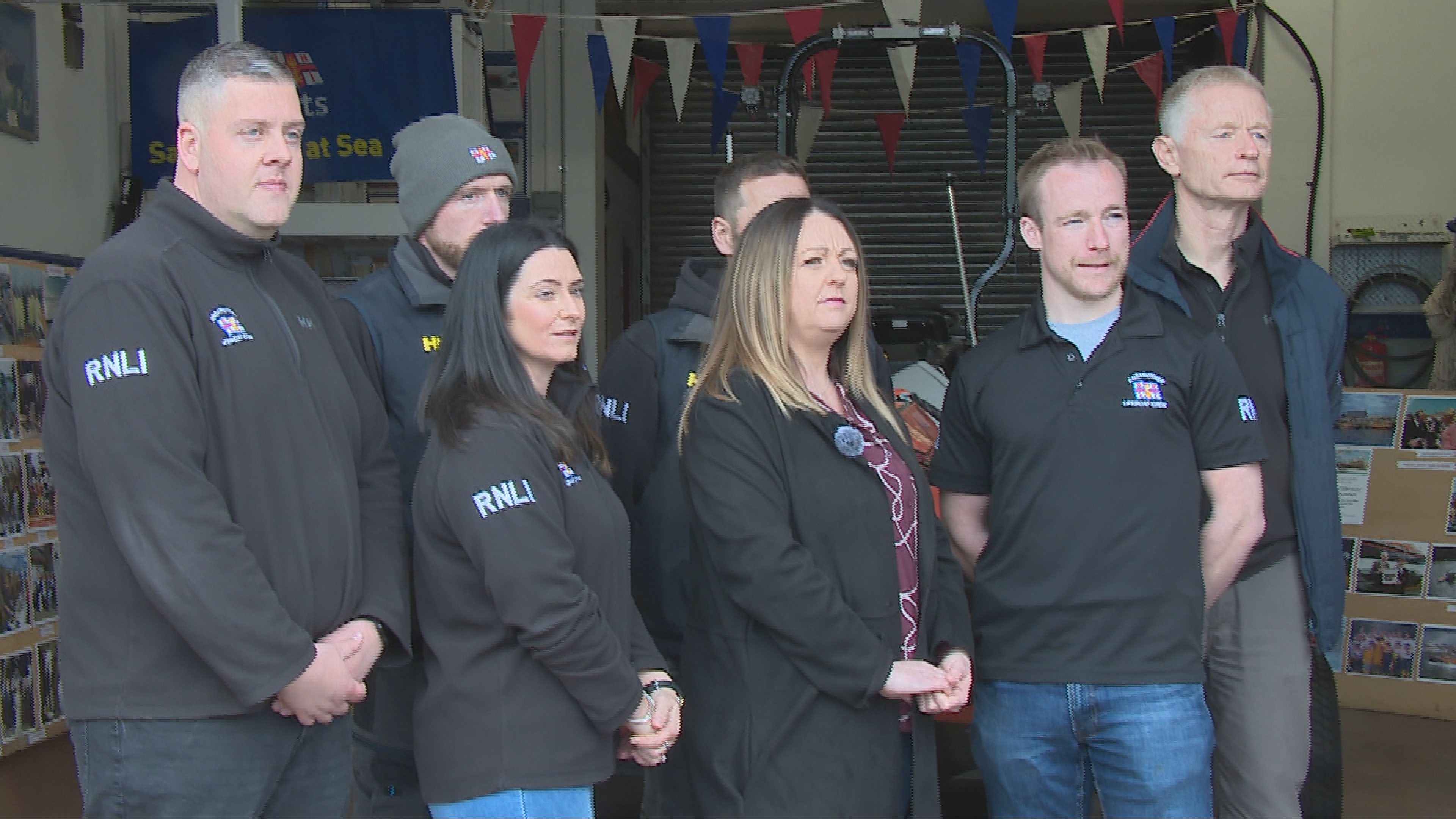 Mandy stands with RNLI volunteers at Anstruther