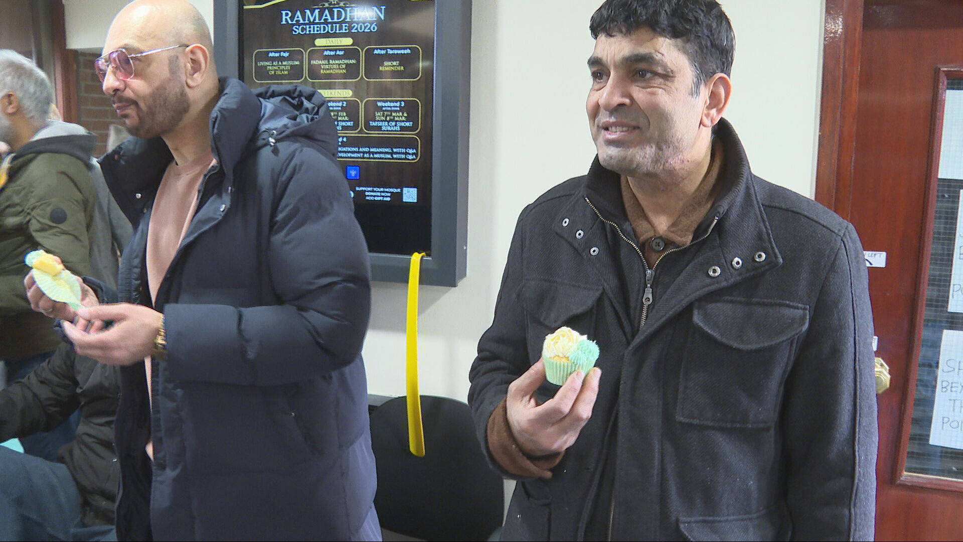 Members of the mosque receive their cupcakes