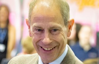 Duke of Edinburgh visits old school to present pipe band with royal banner