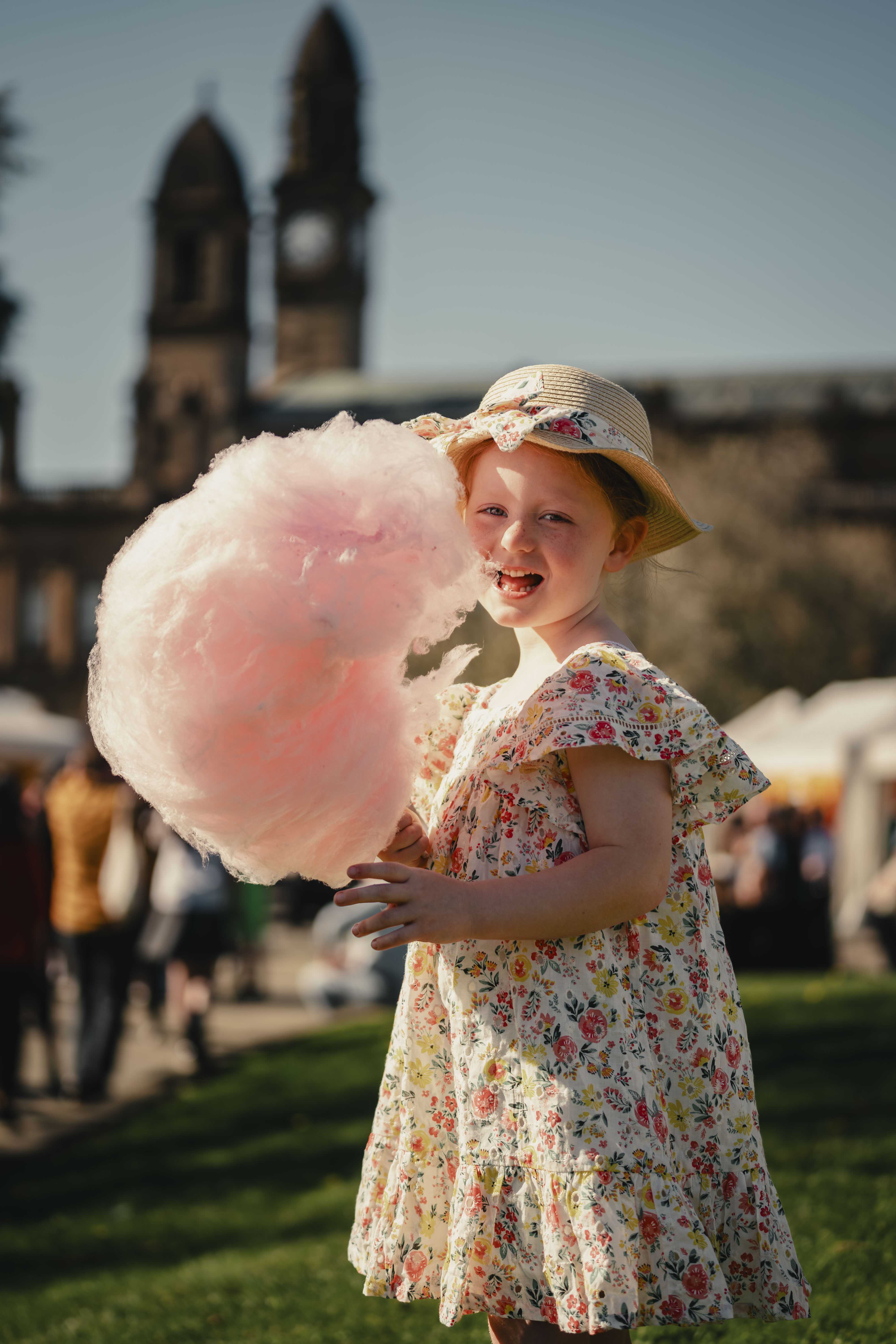A little girl enjoys candy floss at Paisley Food and Drink Festival 2026.