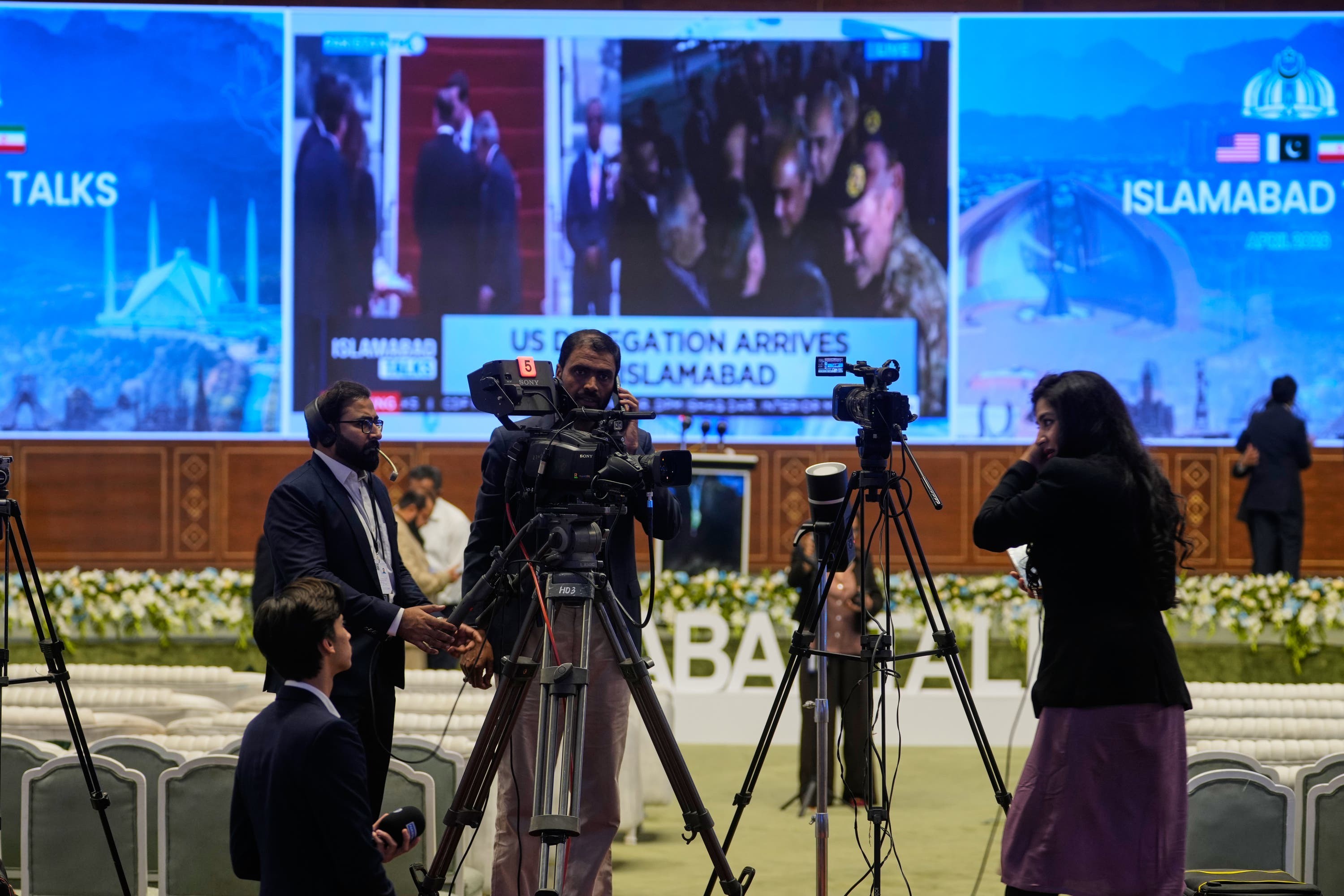 Members of the media cover the US-Iran talks in Islamabad